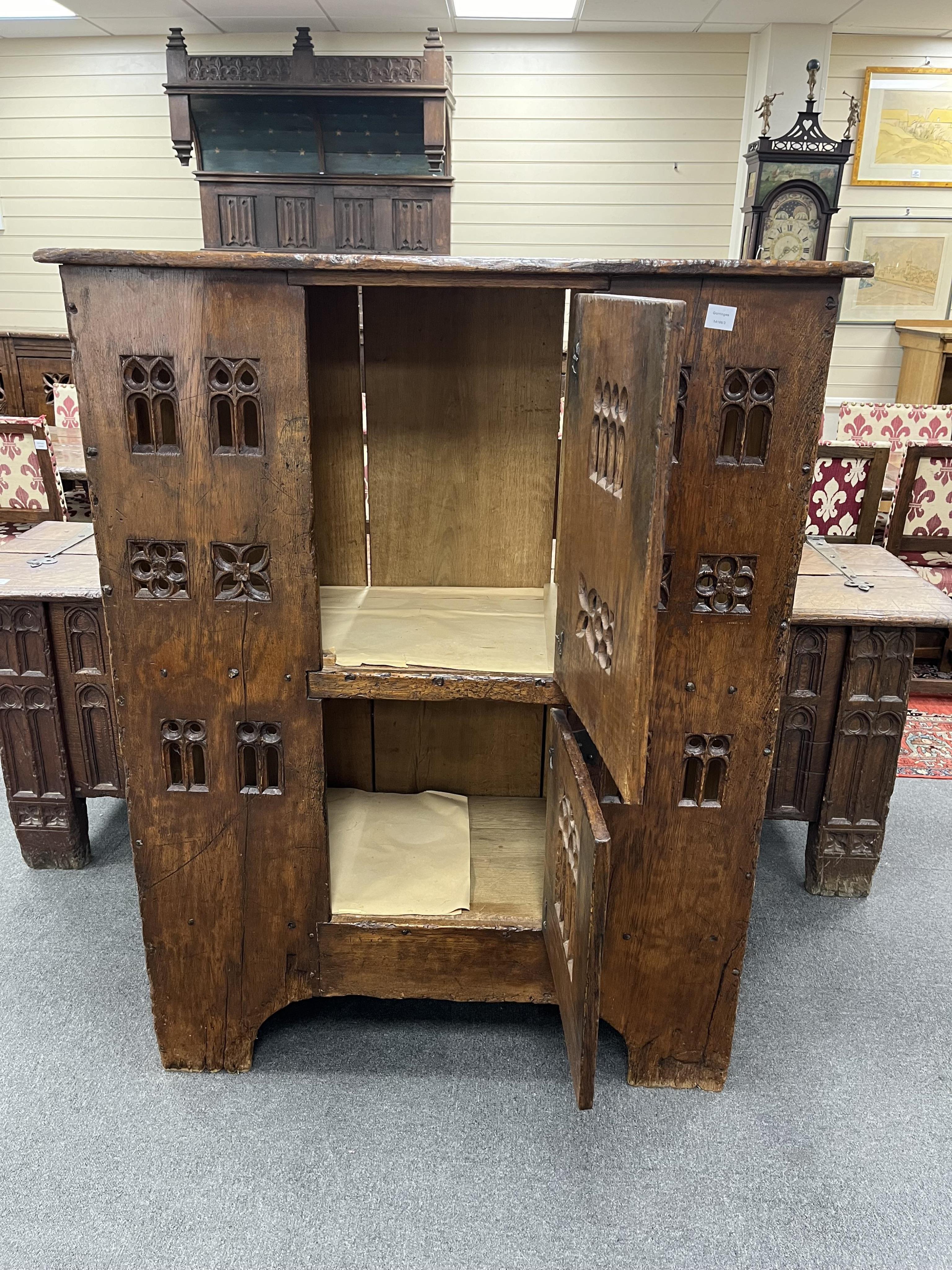 A large Gothic oak aumbry, in late 15th century style, with pierced fretwork panels, width 118cm, depth 53cm, height 151cm. Condition - good, Provenance - made for Brede Place, Brede, Rye, East Sussex. Commissioned from